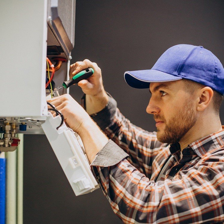 Heating Services 9 AC technician repairing a residential cooling unit